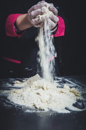 hands pouring flour