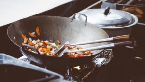 sateuing vegetable in a wok pan